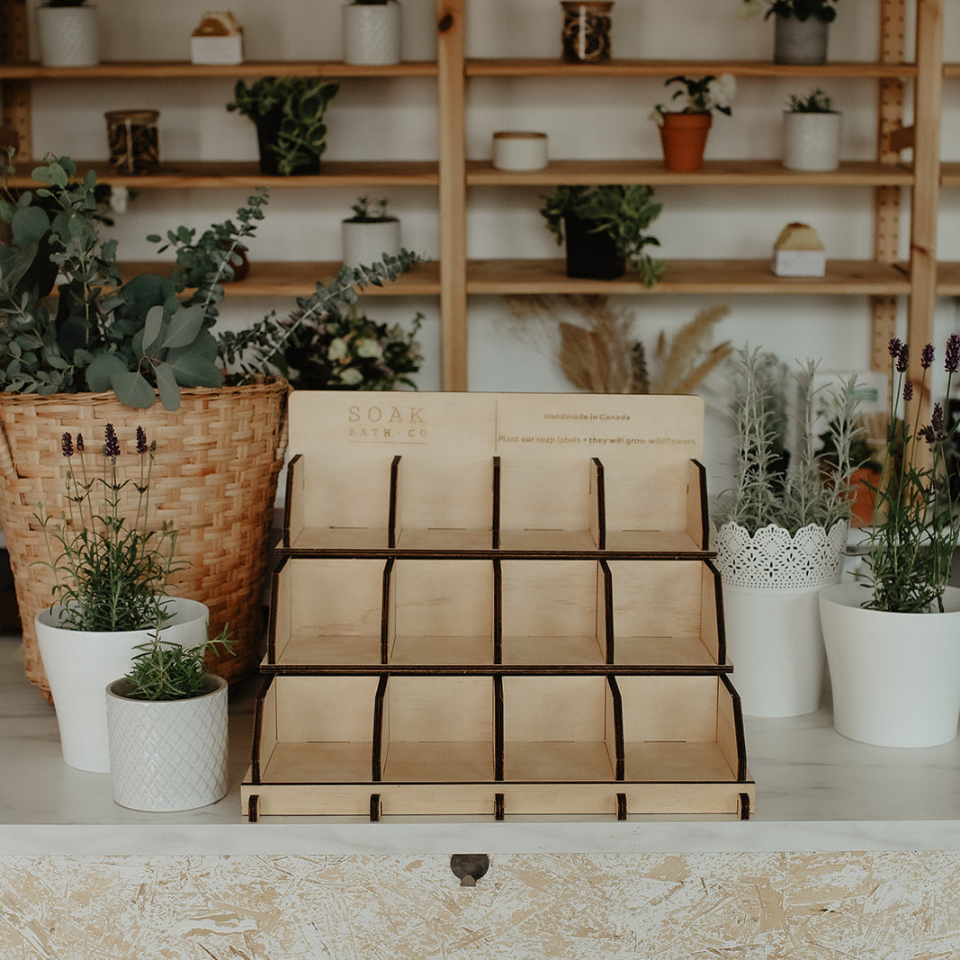 Wooden plant stand with plants on a shelf in a home setting