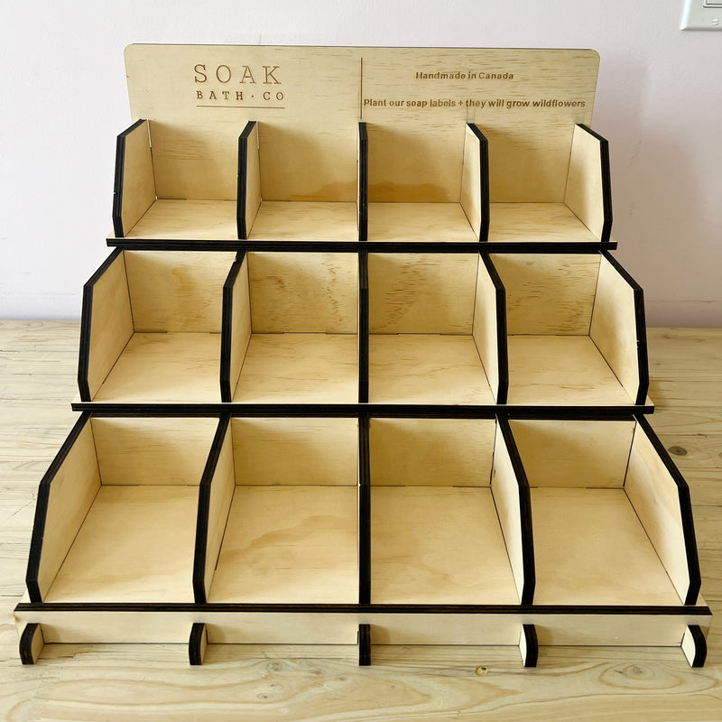 Wooden display rack with multiple compartments to display soap by SOAK Bath co