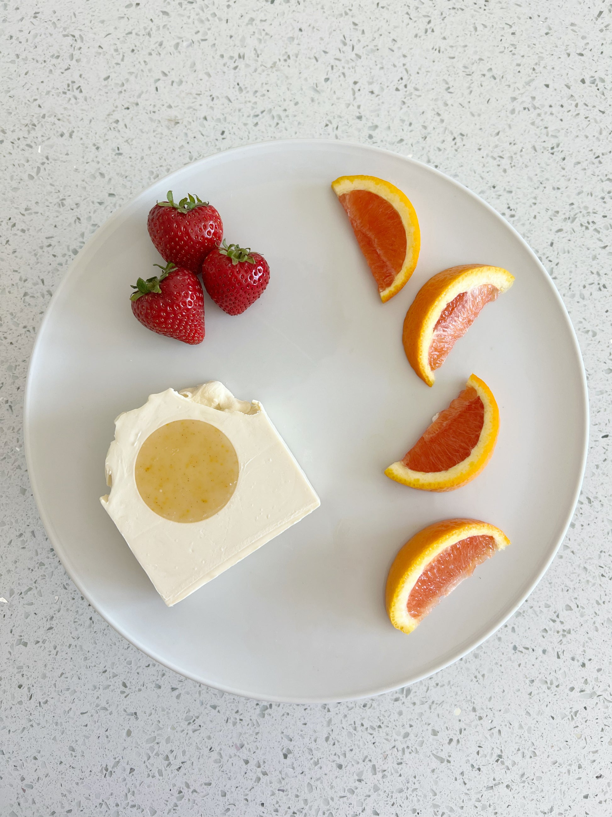 Soap Bar with sliced grapefruit and strawberries on a white plate