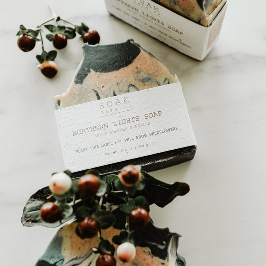 Two soap bars with decorative elements on a white surface