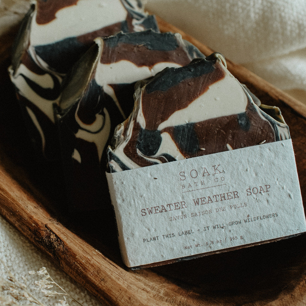 Bar of soap with a label on a wooden tray